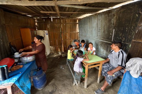 Woman cooking for her family in simple kitchen