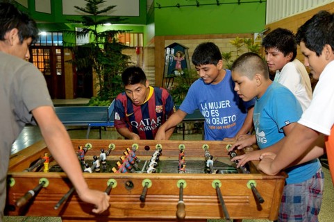 Teenagers playing foosball table