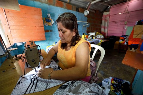 Seamstress in Comuna 8 slum