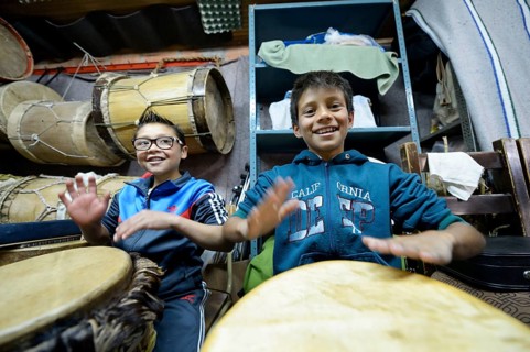 Boys drumming happily