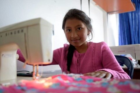 Girl using sewing machine