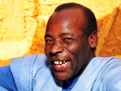 Portrait of a laughing man wearing a blue boubou