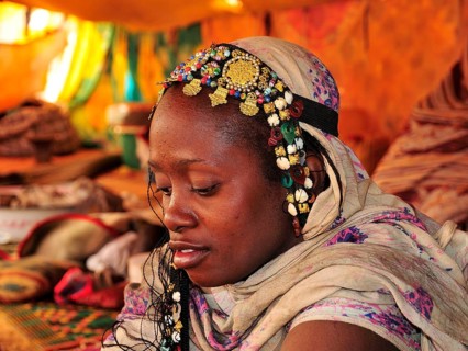 Woman with headdress in a tent
