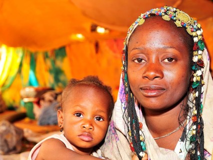 Woman with headdress with her child