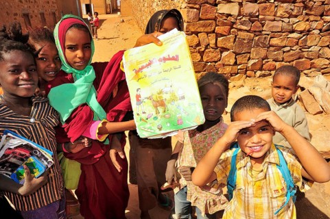 Children showing a textbook