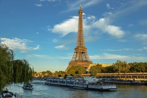 Eiffel Tower with passenger ferry Bateaux Mouches on the Seine