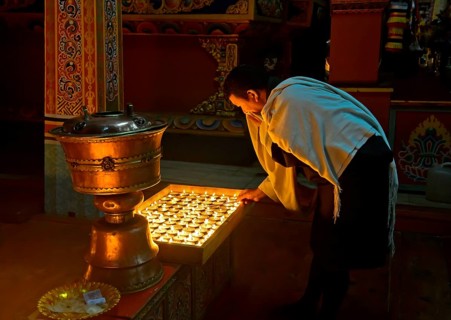 Bhutanese man at the ceremony of the 1000 butter lamps in a Buddhist monastery