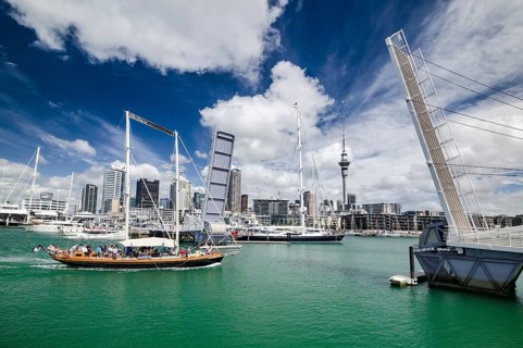 Yacht reaching the Auckland Harbor crossing an open drawbridge