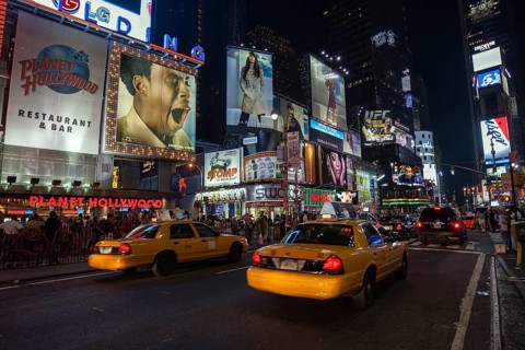 Taxis and illuminated advertising at night
