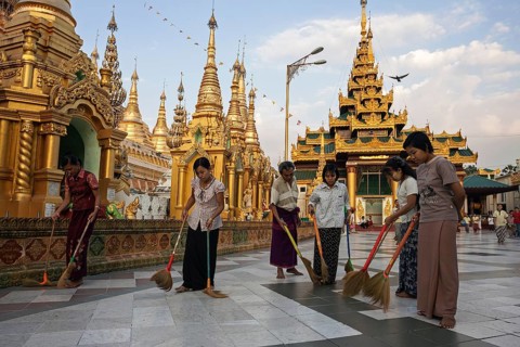 Women sweeping the floor at the site of the Shwedagon Pagoda