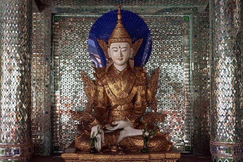 Buddha statue inside a shrine with mirror mosaic
