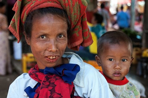 Local woman with typical headgear with child