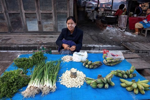 Local woman selling vegetables at the market in Nyaungshwe