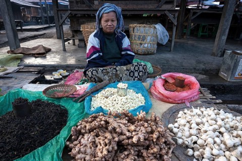 Local woman selling vegetables at the market in Nyaungshwe