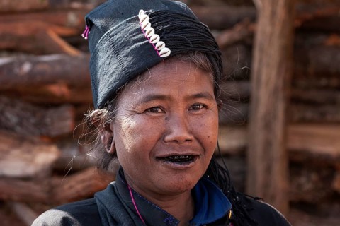 Native woman in typical clothing and headgear from the Ann tribe in a mountain village at Pin Tauk