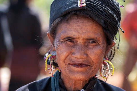 Native woman in typical clothing and headgear from the Ann tribe in a mountain village at Pin Tauk