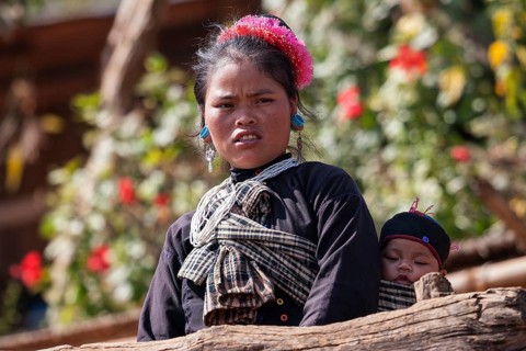 Native young woman with young child in typical clothing