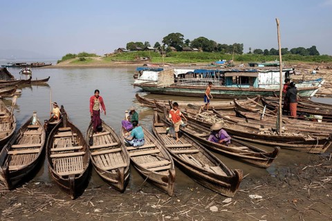 Many wooden boats at the dock in the river Irrawaddy
