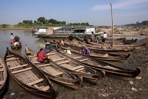 Many wooden boats at the dock in the river Irrawaddy