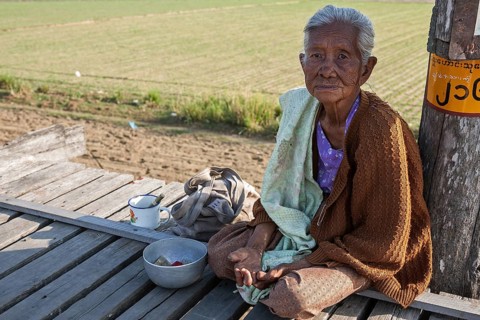 Native leper woman sitting on the U Bein Bridge