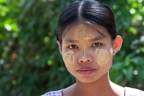 Young woman with Thanaka paste on her face
