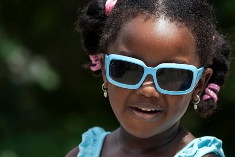 Local girl with white sunglasses and pigtails