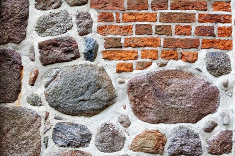 Old stone wall made of rocks and bricks