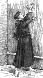 Martin Luther nailing his theses to the door of the castle church in Wittenberg