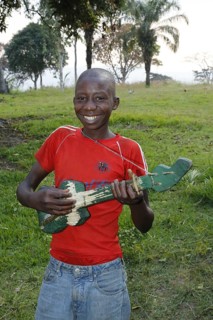 Boy playing on a home-built guitar