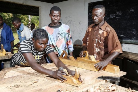 Apprentices planing wood