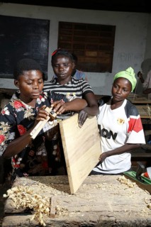 Apprentices planing wood