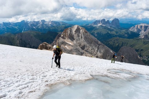 Climbers crossing snow covered area at the summit Punta Penia