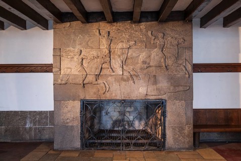 Fireplace with hunting scene relief