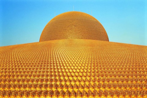 Buddhist temple Wat Phra Dhammakaya with golden Dhammakaya Buddha statues on the Chedi