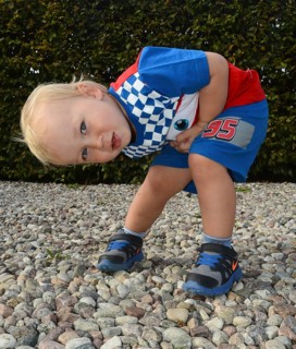 Little blond boy in colorful outfit