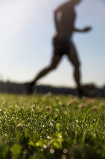 Jogger running in grass