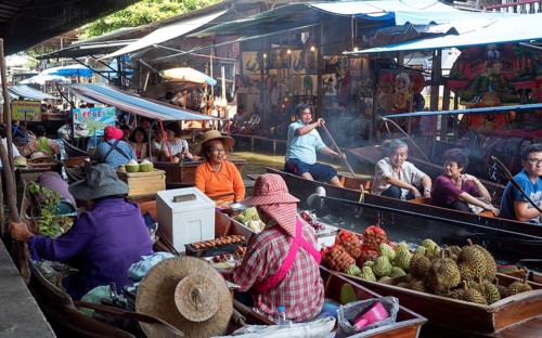 Floating Market with boats and sellers on a canal or Khlong