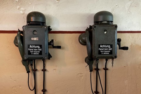 Two telephones in a bunker from the 2nd World War with inscription