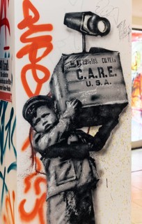 Young boy carrying US-care package with surveillance camera