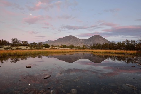 The peaks of the Stygghoin or Stygghoin mountain group reflected in a small lake