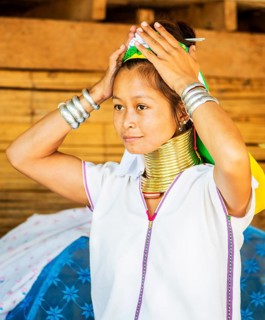 Young Kayan hill tribe woman does her hair in the morning