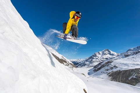 Snowboarder jumping in deep snow