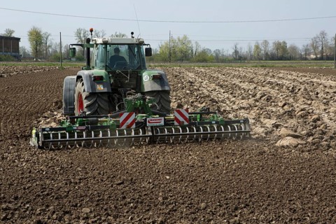 Tractor plowing a field in spring