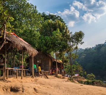 People sitting in front of wooden huts