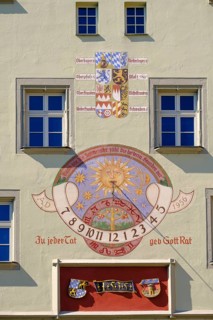 Coat of arms and sundial on facade