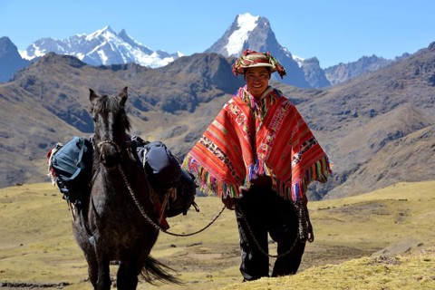 Indio mountain guide with colorful poncho and horse