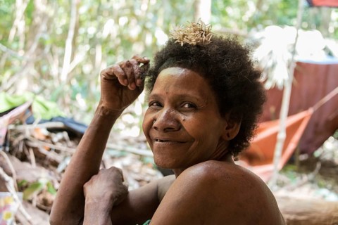 Woman of the Orang Asil tribe sitting in the jungle
