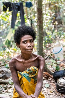 Woman of the Orang Asil tribe sitting in the jungle