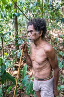 Old Man of the Orang Asil tribe with a blowgun in the jungle