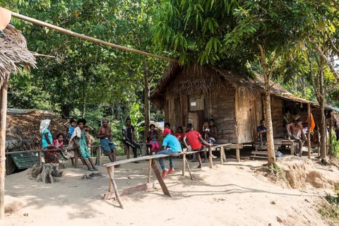 People sitting in front of wooden huts
